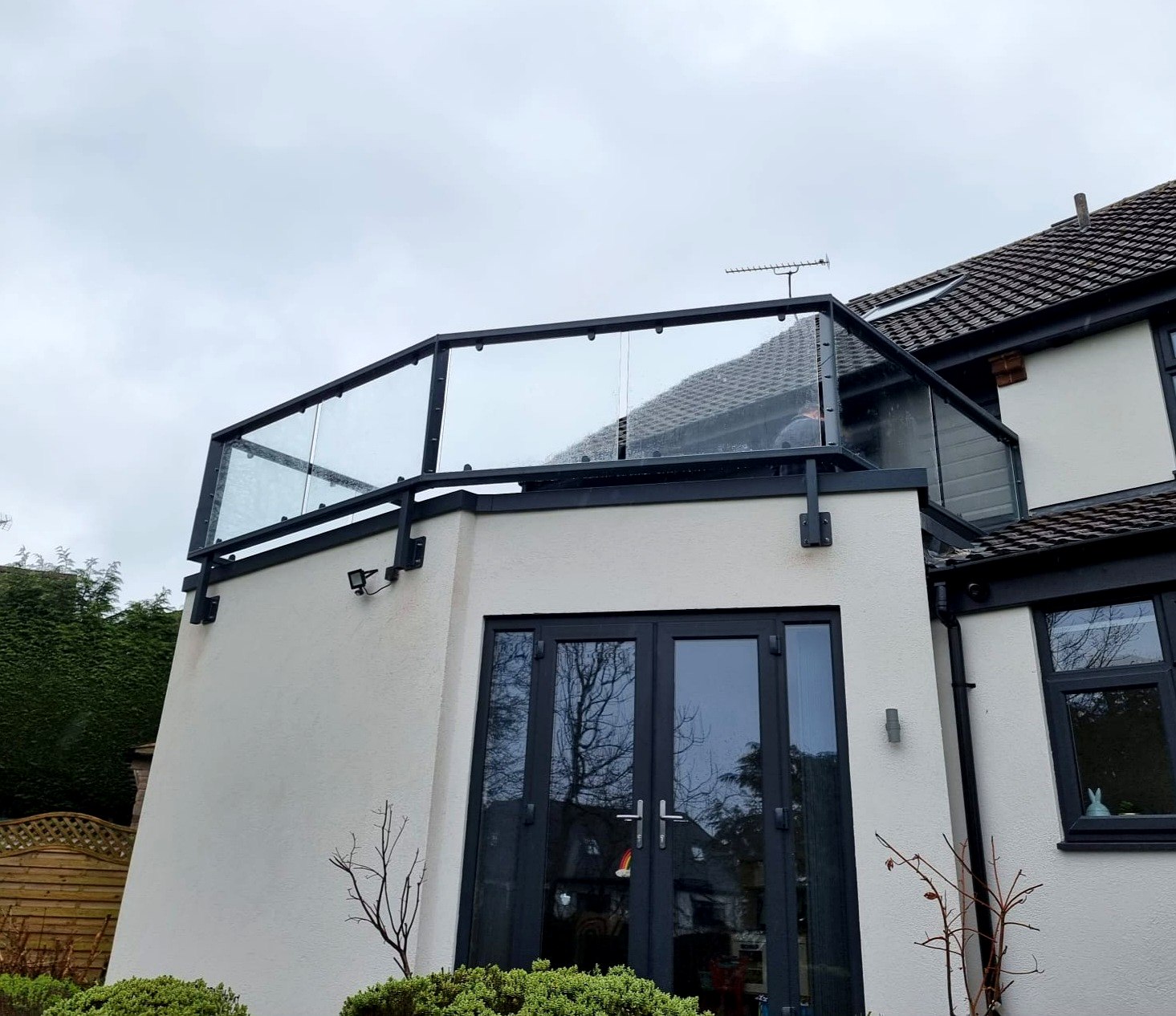 Anthracite grey glass balcony balustrade matched to the windows on an irregular balcony, Norton